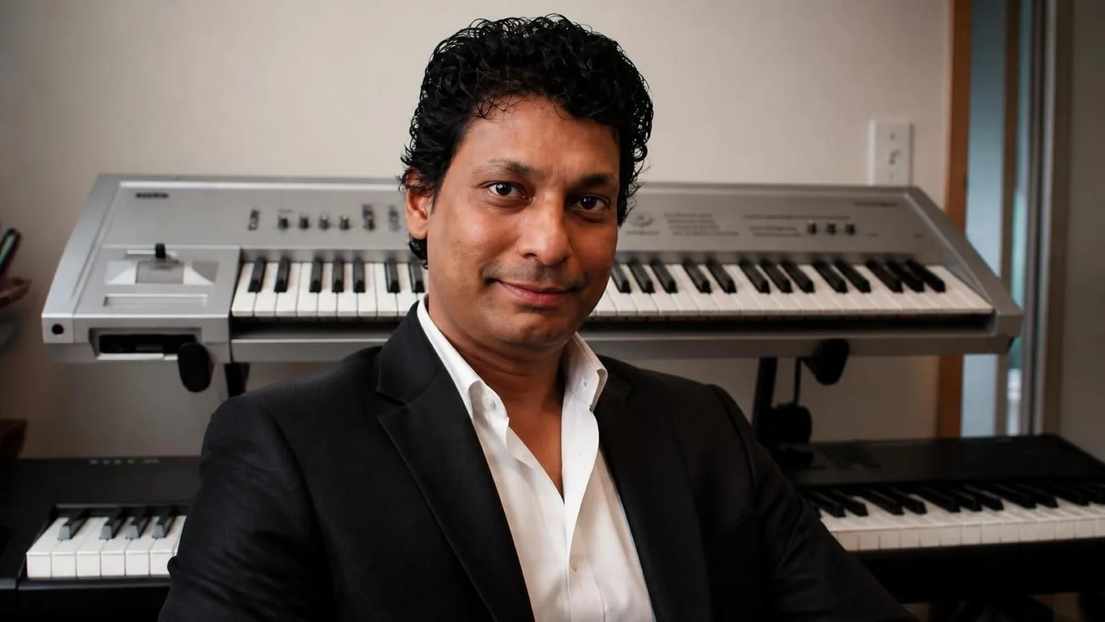 Behleem in a jacket at the keyboard